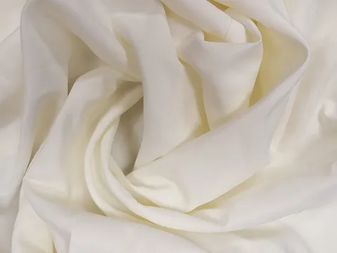 Close-up of ivory polyester tablecloth fabric