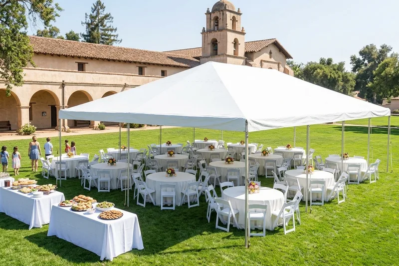 Church picnic on a lawn with round tables under a white frame canopy and rectangle food tables to the side